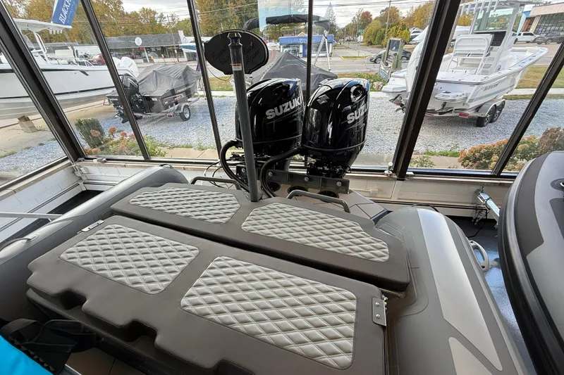 Slide: The Image of 2025 Highfield Sport 800 boat with Suzuki engines in showroom display. - 17