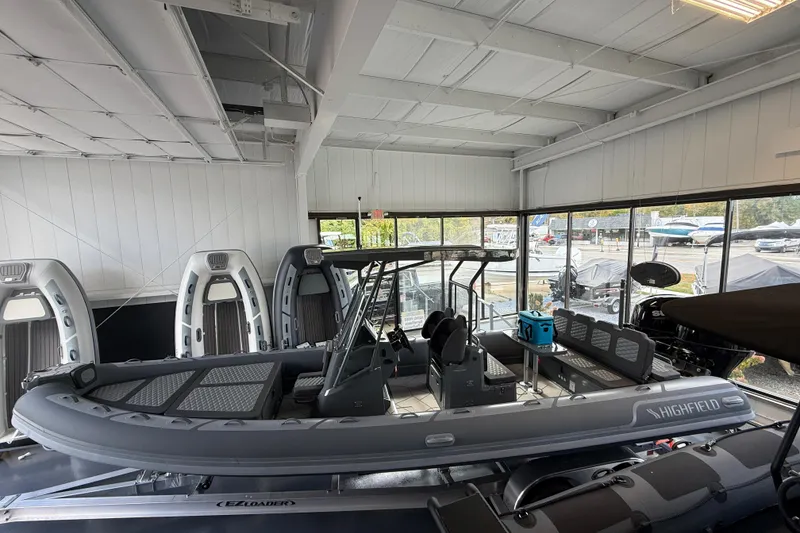 Slide: The Image of 2025 Highfield Sport 800 boat displayed in a showroom, featuring sleek design and modern amenities. - 22