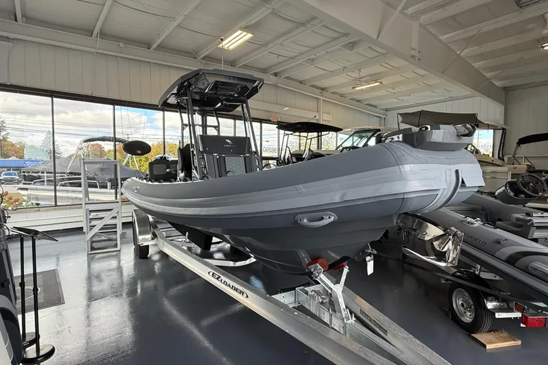 Slide: The Image of 2025 Highfield Sport 800 boat displayed indoors on a trailer. - 3