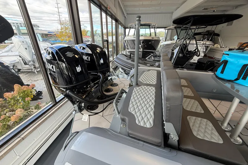 Slide: The Image of 2025 Highfield Sport 800 boat interior with Suzuki engines in showroom display. - 6