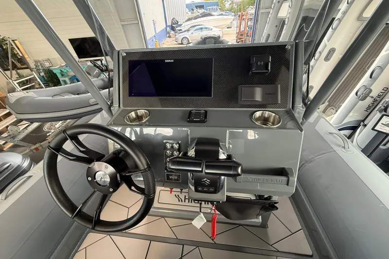 Slide: The Image of 2025 Highfield Sport 800 boat dashboard with steering wheel and control panel. - 8