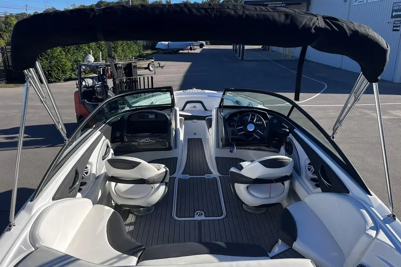 Slide: The Image of 2022 Monterey 224FS boat interior with seating and steering wheel, under a black canopy. - 4