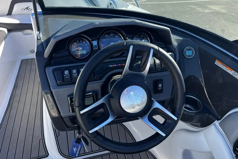 Slide: The Image of 2022 Monterey 224FS boat dashboard with steering wheel and instrument panel. - 5