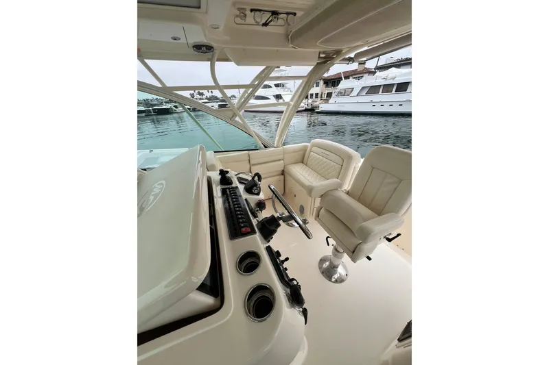 Slide: The Image of 2018 Grady-White Express 370 boat deck with triple outboard motors in marina. - 10