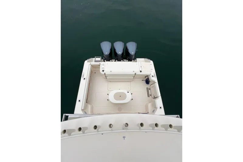 Slide: The Image of 2018 Grady-White Express 370 helm with Garmin navigation system on calm water. - 15