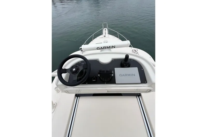 Slide: The Image of Helm of 2018 Grady-White Express 370 with Garmin navigation, overlooking marina. - 17