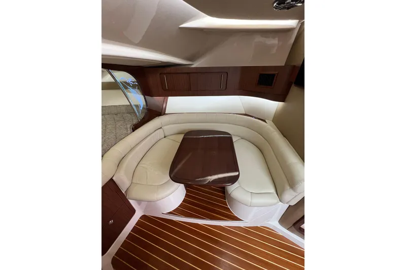 Slide: The Image of Interior of 2018 Grady-White Express 370, featuring elegant seating and wood flooring. - 25
