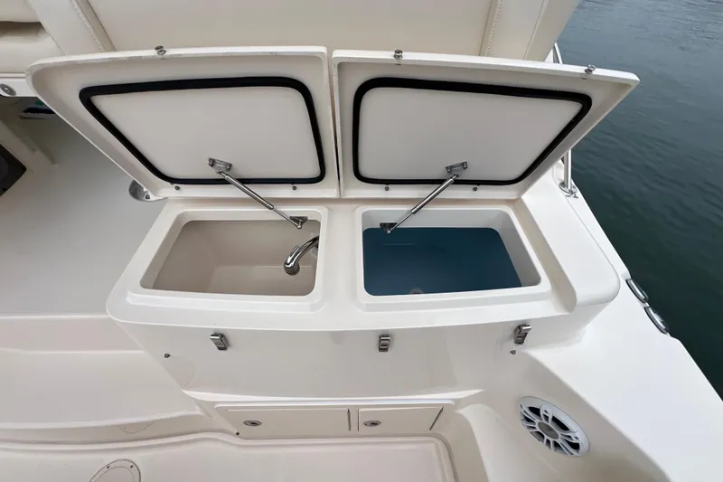Slide: The Image of 2018 Grady-White Express 370 boat with open storage compartments on deck. - 6