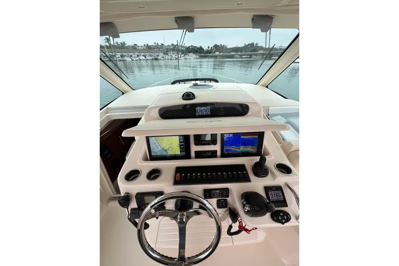 Slide: The Image of 2018 Grady-White Express 370 boat interior with helm and seating, docked at marina. - 9