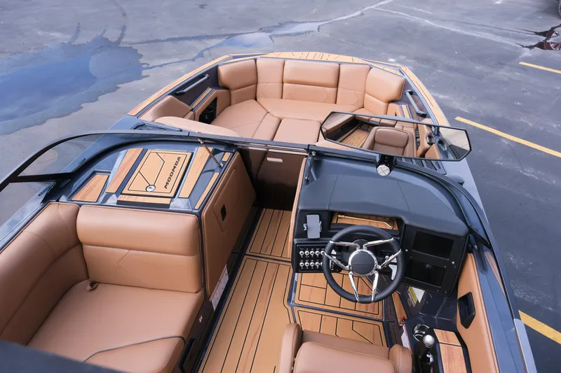 Slide: The Image of 2026 Moomba Tykon boat interior with tan seating and modern dashboard design. - 11