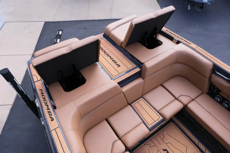Slide: The Image of 2026 Moomba Tykon boat interior with tan leather seating and adjustable backrests. - 12