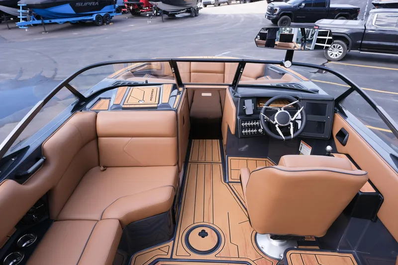 Slide: The Image of 2026 Moomba Tykon boat interior with tan seating and modern dashboard design. - 15