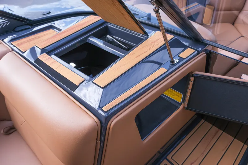 Slide: The Image of 2026 Moomba Tykon interior with open storage compartments and wood accents. - 27