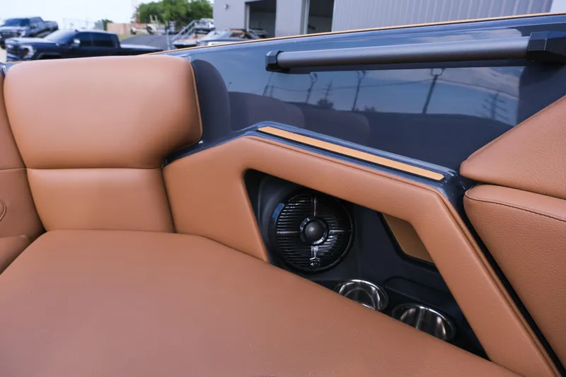 Slide: The Image of 2026 Moomba Tykon boat interior with tan leather seats and built-in speaker. - 29