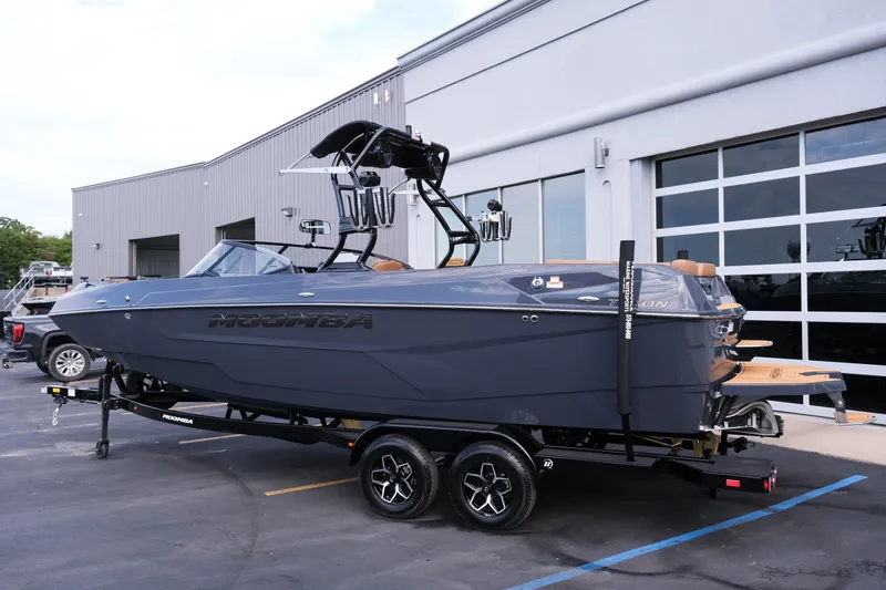 Slide: The Image of 2026 Moomba Tykon boat on trailer outside modern building. - 3