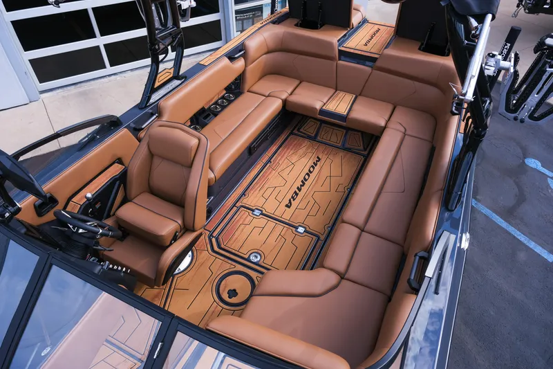 Slide: The Image of 2026 Moomba Tykon boat interior with luxurious brown seating and modern design. - 32