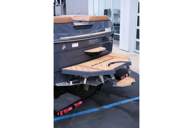 Slide: The Image of 2026 Moomba Tykon boat rear view with teak swim platform and step detail. - 5