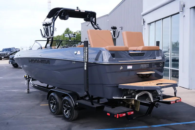 Slide: The Image of 2026 Moomba Tykon boat on trailer, parked outside a building. - 6