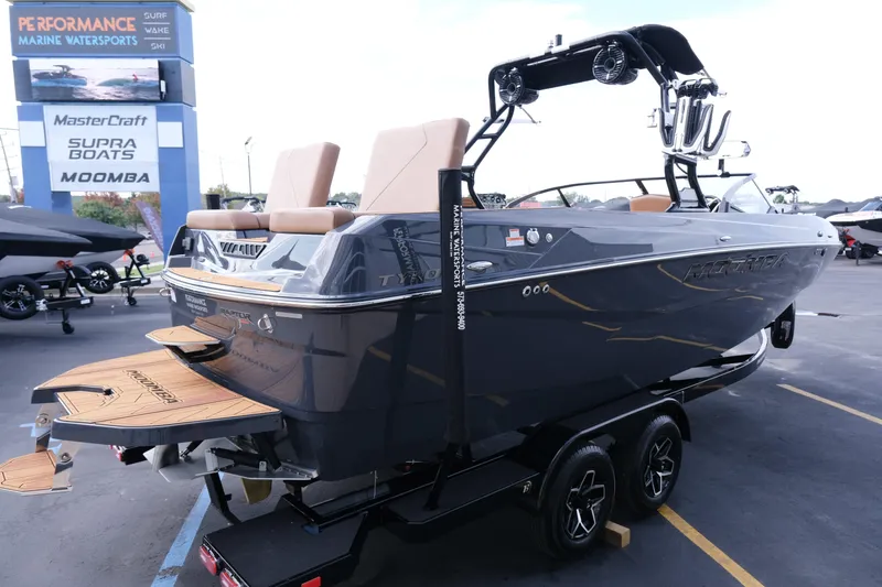 Slide: The Image of 2026 Moomba Tykon boat on trailer at marine dealership, showcasing sleek design and features. - 9