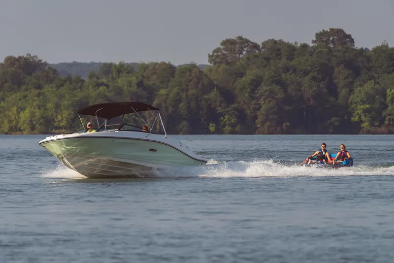 Slide: The Image of Manufacturer Provided Image: 2024 Sea Ray SPX 230 boat towing two people on a lake. - 12