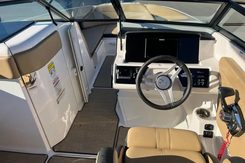 Slide: The Image of 2024 Sea Ray SPX 230 boat interior with steering wheel and control panel. - 6