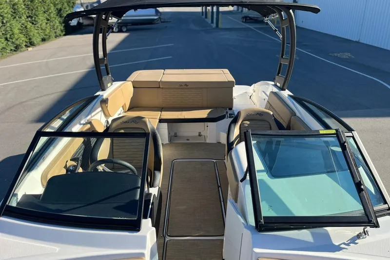 Slide: The Image of 2024 Sea Ray SPX 230 boat interior with tan seating and sleek design. - 7