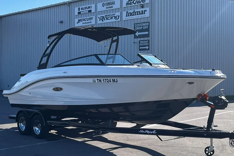 Slide: The Image of 2024 Sea Ray SPX 230 boat on trailer, parked outside a marine dealership. - 8
