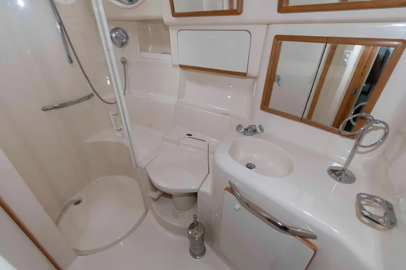 Slide: The Image of Bathroom interior of 1995 Sea Ray 440 Sundancer yacht, featuring shower and sink. - 12