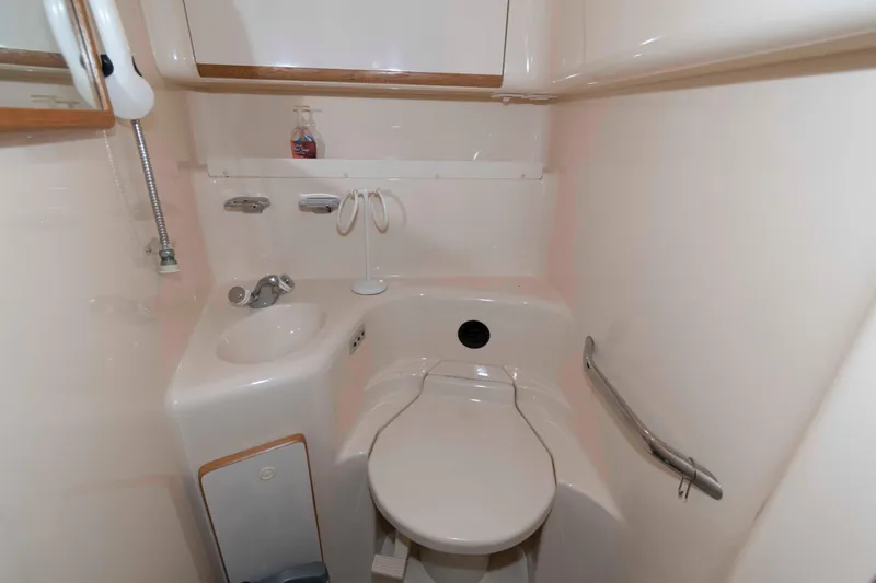 Slide: The Image of Bathroom interior of 1995 Sea Ray 440 Sundancer yacht, featuring sink and toilet. - 14
