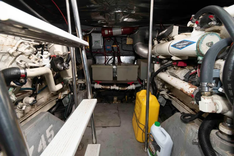 Slide: The Image of Engine room of a 1995 Sea Ray 440 Sundancer with visible machinery and equipment. - 15