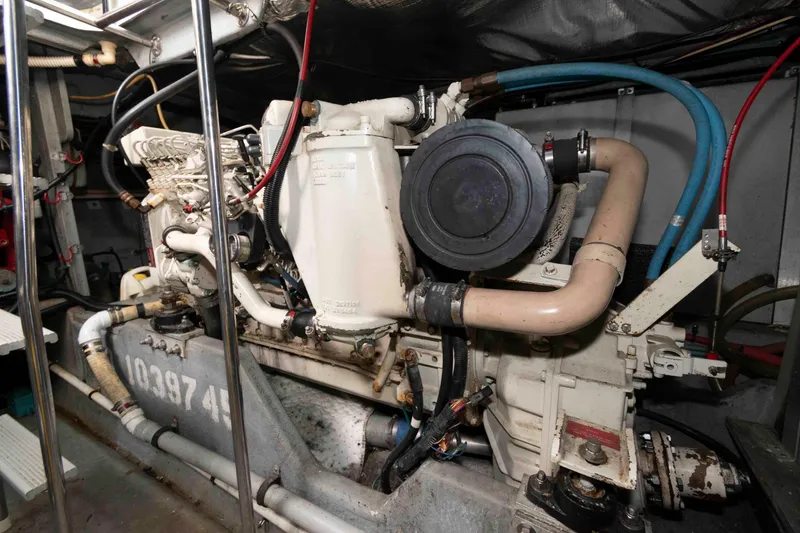 Slide: The Image of Engine room of a 1995 Sea Ray 440 Sundancer boat, showcasing mechanical components. - 19