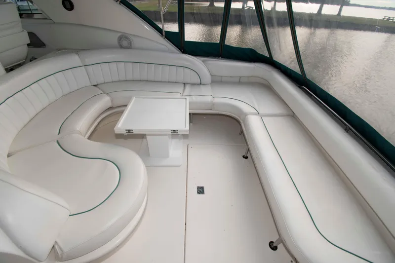 Slide: The Image of Luxurious seating area on a 1995 Sea Ray 440 Sundancer yacht, featuring white leather upholstery. - 3