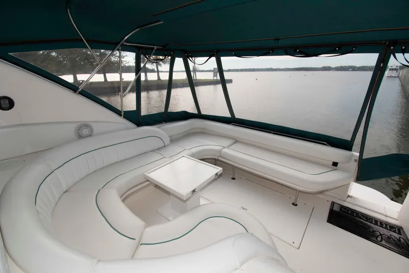 Slide: The Image of Luxurious 1995 Sea Ray 440 Sundancer yacht interior with white seating and scenic water view. - 7
