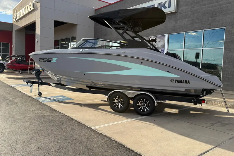 Slide: The Image of 2026 Yamaha Boats 255XD displayed on a trailer outside a dealership. - 12