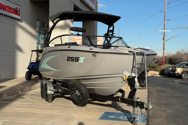 Slide: The Image of 2026 Yamaha Boats 255XD on trailer outside dealership, showcasing sleek design and modern features. - 4