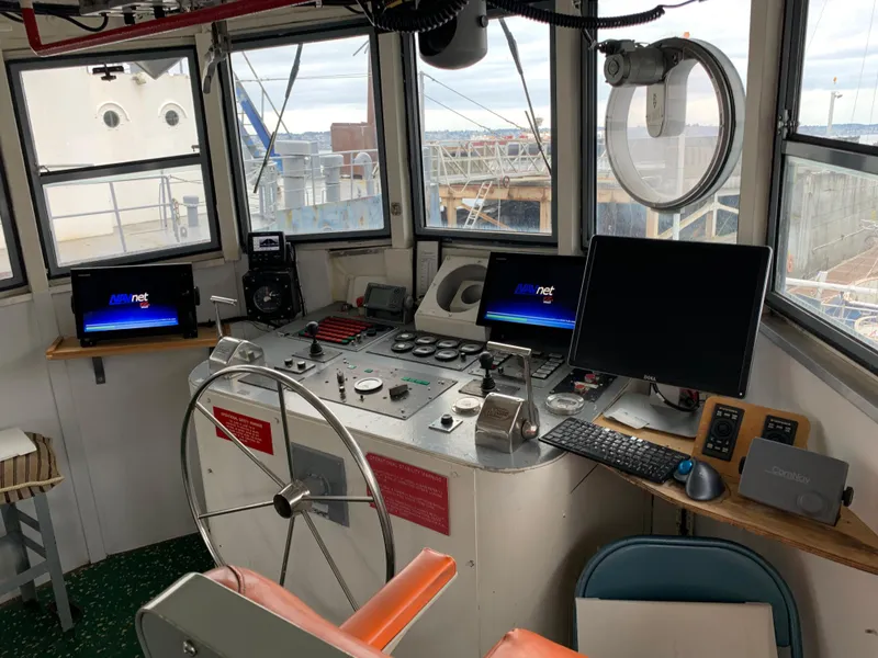 Slide: The Image of 1955 Tugboat L-T 100 Steel Army Tug control room with modern navigation equipment. - 17