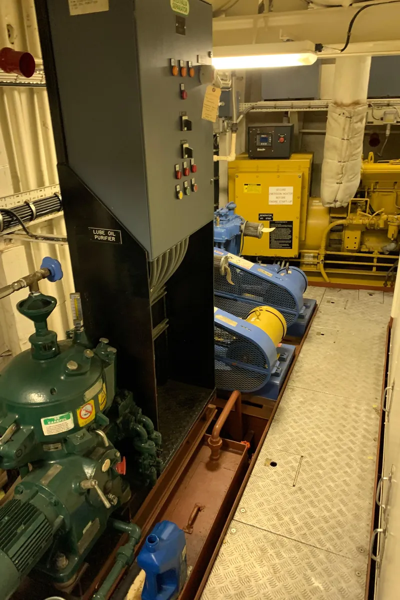 Slide: The Image of Engine room of 1955 Tugboat L-T 100 Steel Army Tug with machinery and control panels. - 36