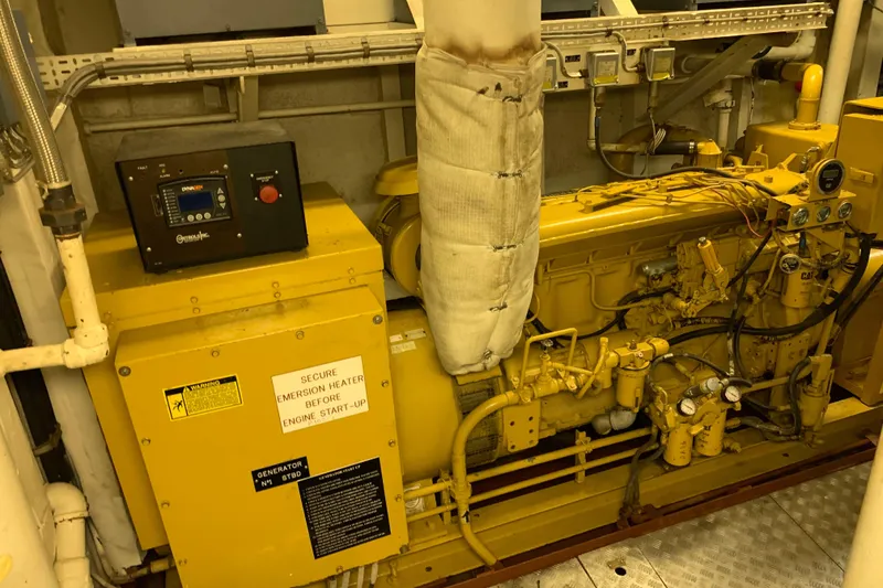 Slide: The Image of Engine room of 1955 Tugboat L-T 100 Steel Army Tug, featuring machinery and control panel. - 38