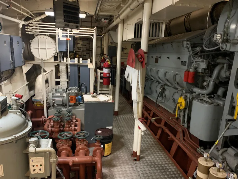 Slide: The Image of Engine room of 1955 Tugboat L-T 100 Steel Army Tug, featuring machinery and control panels. - 39