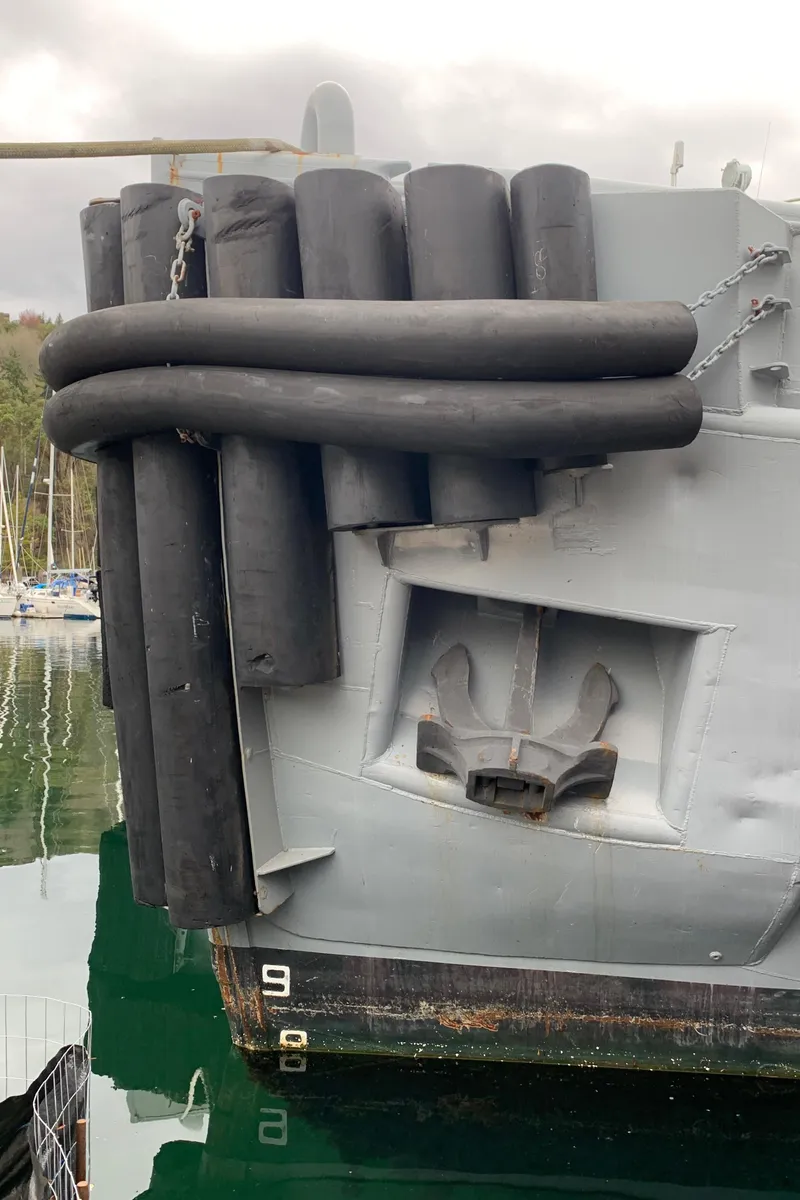 Slide: The Image of 1955 Tugboat L-T 100 Steel Army Tug with rubber fenders in harbor. - 7