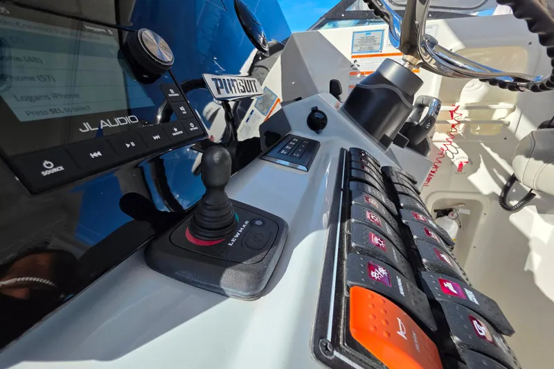 Slide: The Image of 2024 Pursuit OS 325 Offshore boat docked under clear blue sky. - 17