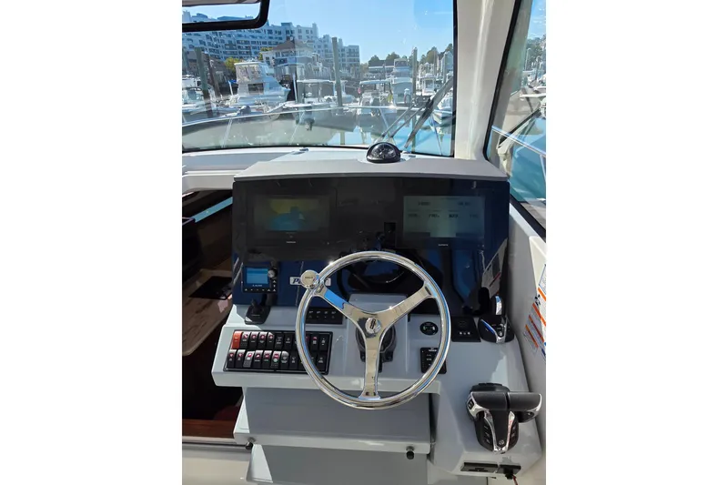 Slide: The Image of Electrical control panel on 2024 Pursuit OS 325 Offshore boat. - 19