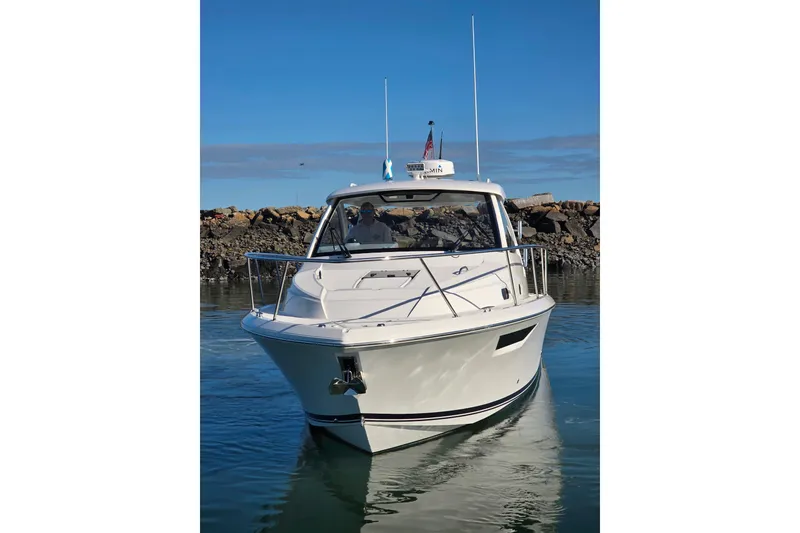 Slide: The Image of 2024 Pursuit OS 325 Offshore boat with open storage compartment at marina. - 27