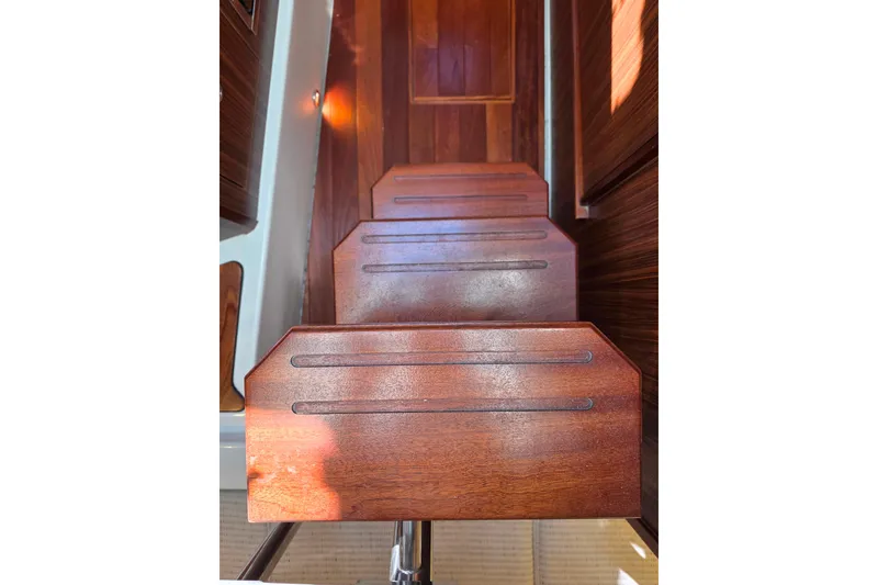 Slide: The Image of 2024 Pursuit OS 325 Offshore boat with luxurious quilted seating in a marina setting. - 29