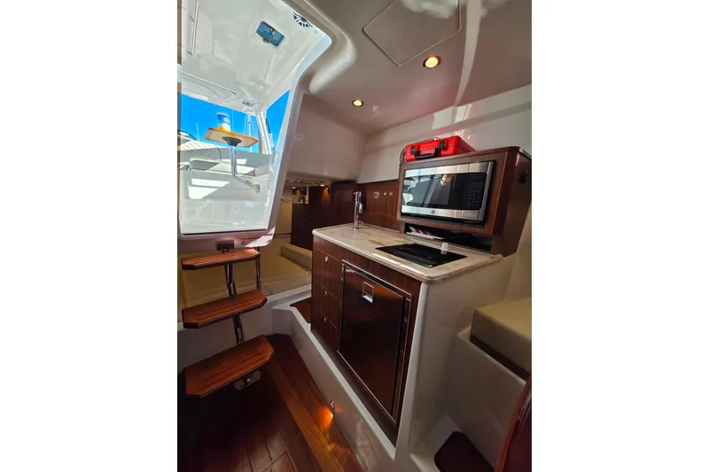 Slide: The Image of 2024 Pursuit OS 325 Offshore boat with quilted seating and storage compartments. - 30