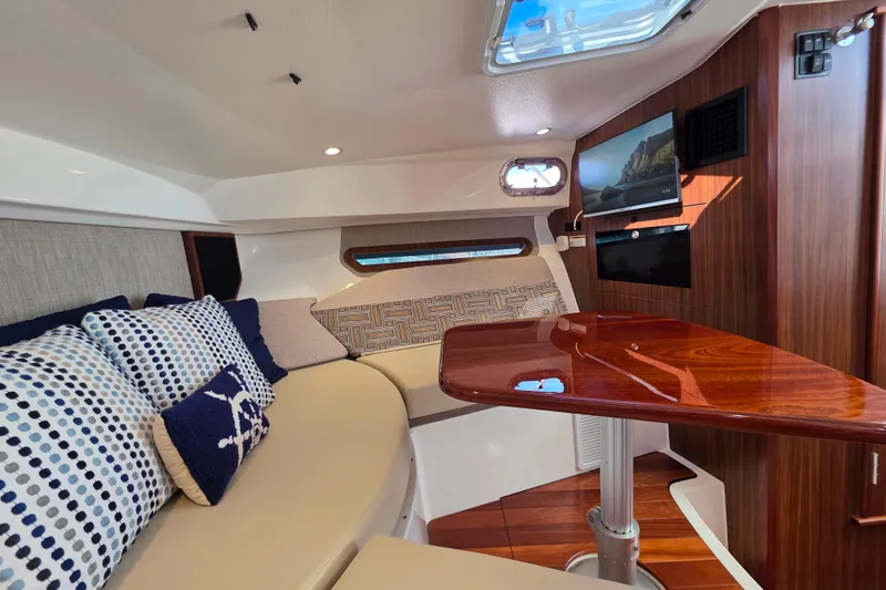 Slide: The Image of Interior of 2024 Pursuit OS 325 Offshore boat, featuring helm and seating area. - 37