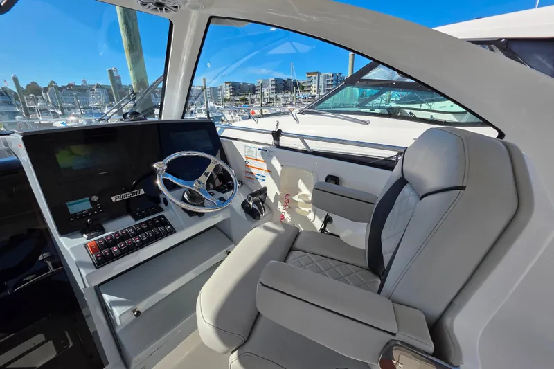Slide: The Image of 2024 Pursuit OS 325 Offshore helm with modern controls and comfortable seating. - 41