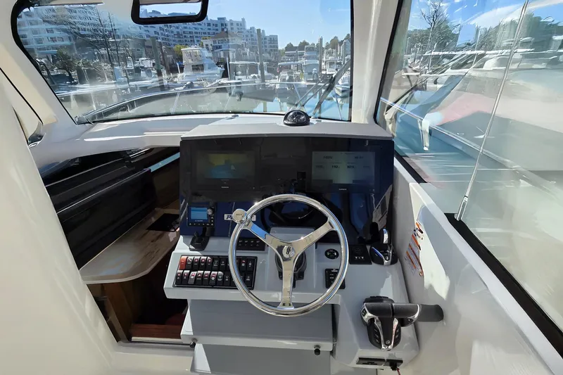 Slide: The Image of 2024 Pursuit OS 325 Offshore helm with modern controls and navigation screens. - 44