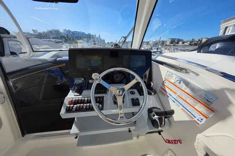 Slide: The Image of 2024 Pursuit OS 325 Offshore helm with modern controls and navigation display. - 45