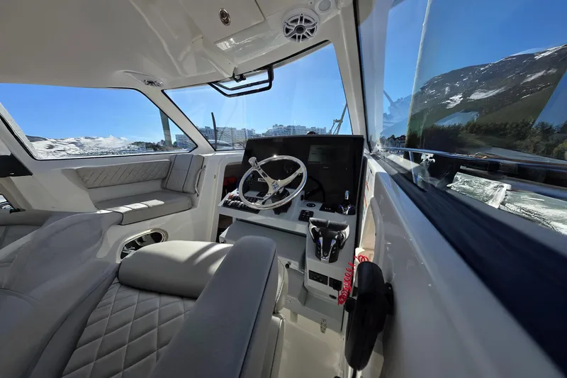 Slide: The Image of 2024 Pursuit OS 325 Offshore boat interior with modern helm and luxurious seating. - 46